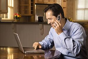 Man on Cell Phone and Laptop