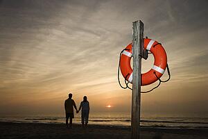 Couple holding hands on beach