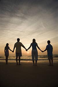 Family Holding Hands on Beach