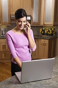 Woman on Cell Phone with Laptop