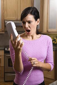 Woman holding phone in disbelief