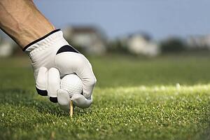 Golfer Placing Tee and Ball