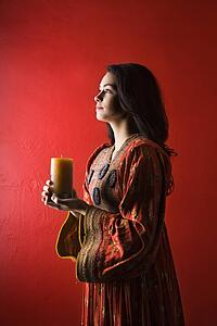 Young Woman Holding Candle