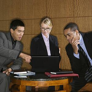 Businesspeople Looking at Laptop