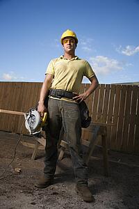Construction Worker Standing with Saw