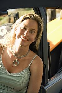 Smiling Woman Sitting in Car