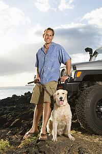 Man and Dog by SUV at the Beach