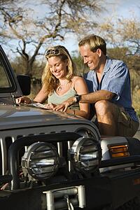 Couple With Map on Car Hood