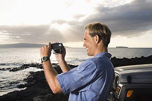 Man Using Video Camera at the Beach