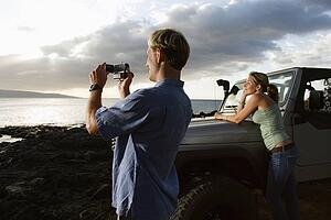 Tourist Couple Enjoying a Beach Sunset