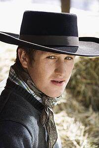 Young Man Wearing a Black Cowboy Hat