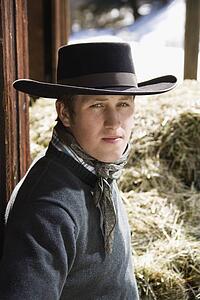 Young Man Wearing a Black Cowboy Hat