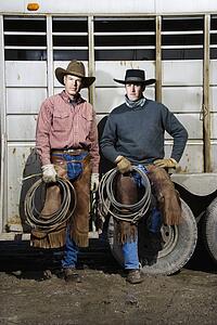 Two Men Wearing Cowboy Hats Holding Lariats