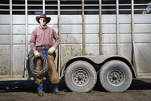 Man Wearing Cowboy Hat Holding Lariat