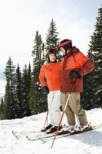 Couple on Skis on Mountain Slope