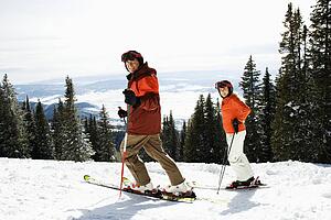 Couple Skiing on Mountain Slope