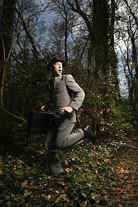 Young Businessman Running In Woods