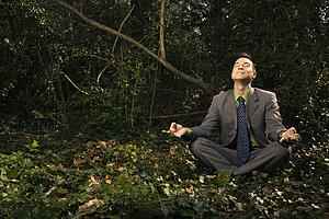 Businessman Sitting in Meditation Outside