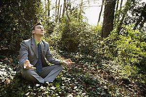Young Businessman Sitting in Meditation