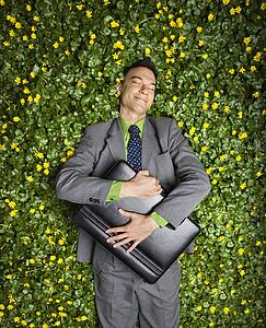 Businessman Lying in Flower Patch