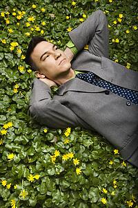 Businessman Lying in Flower Patch