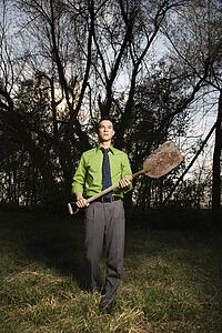 Young Businessman Holding Shovel