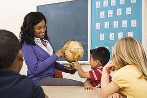 Teacher Holding Globe