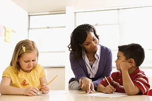 Teacher Helping Students With Schoolwork 
