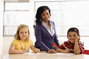 Teacher Helping Students With Schoolwork 