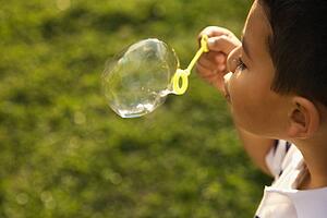 Young Boy Blowing Bubbles
