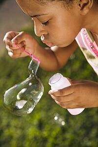 Young Girl Blowing Bubbles