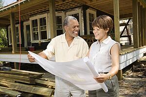 Couple Holding Building Plans