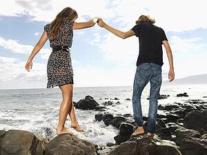Young Couple Walking at Beach