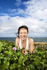 Woman Lying in Plants Near Beach