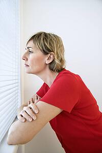Woman looking out window.