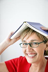 Woman with book on her head