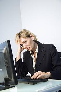 Businesswoman rubbing head.