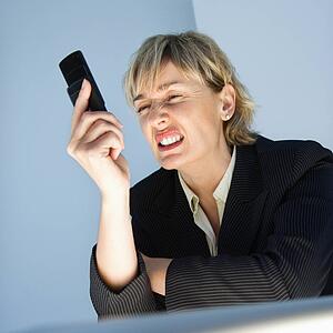 Businesswoman frustrated with cellphone