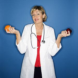Doctor holding fruit