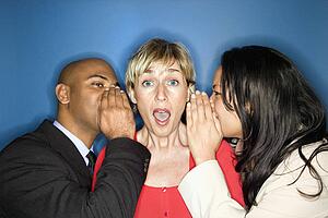 Businesspeople telling secrets