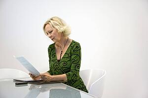 Businesswoman reading paperwork