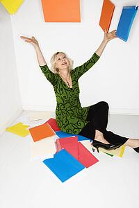 Businesswoman throwing folders