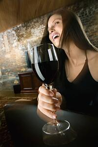 Woman drinking and laughing