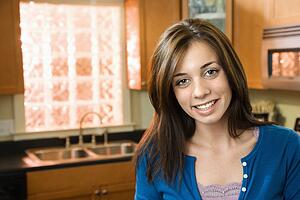 Smiling woman in kitchen