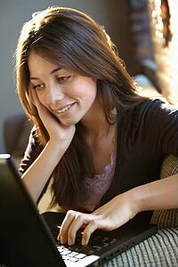 Happy woman using laptop