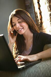 Woman on phone using computer