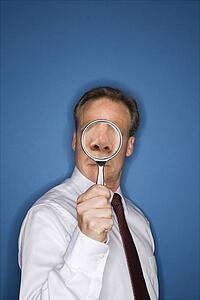 Businessman with magnifier