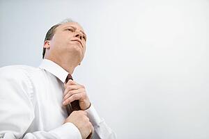 Businessman tying tie