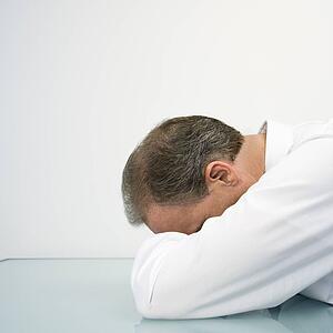 Businessman with head on desk
