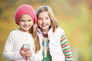 Two Young Girl Outdoors With MP3 Player